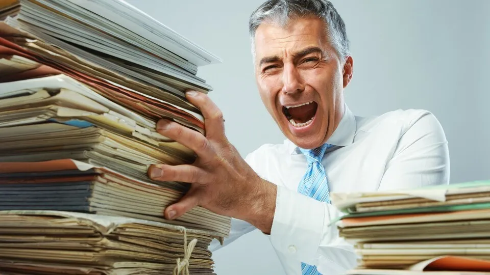 Overworked mature business man screaming in anger
